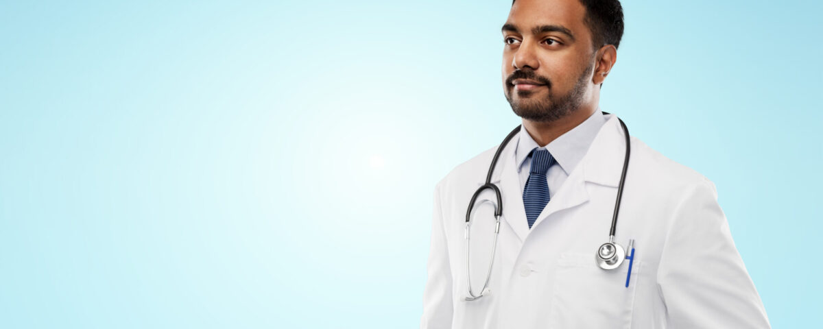 MBBS doctor exploring fellowship courses without NEET PG on a laptop in a modern clinical setting