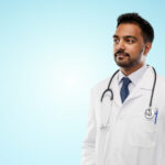 MBBS doctor exploring fellowship courses without NEET PG on a laptop in a modern clinical setting