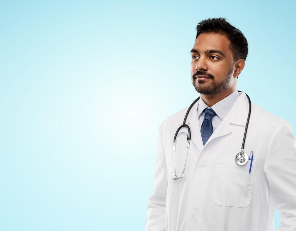 MBBS doctor exploring fellowship courses without NEET PG on a laptop in a modern clinical setting